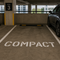 Compact stencil applied to a parking space inside of a parking garage