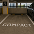 Compact stencil applied to a parking space inside of a parking garage
