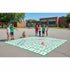 Children playing on a large number grid on a school playground.