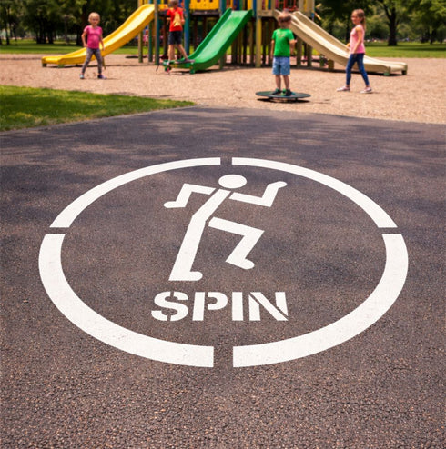 Playground surface with a 'Spin' marker and children playing in the background