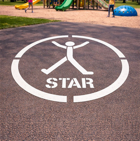 White 'STAR' logo on a playground surface with children playing in the background.