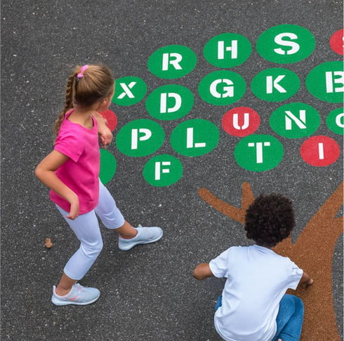 Two children playing on the alphabet tree playground stencil.