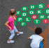 Two children playing on the alphabet tree playground stencil.