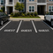 Guest Stencil applied to the parking spaces in an apartment building parking lot.