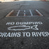 Environmental message with fish icon and text 'No Dumping Drains to River' on a white background