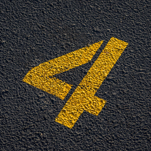 Parking lot number stencil applied to a parking lot