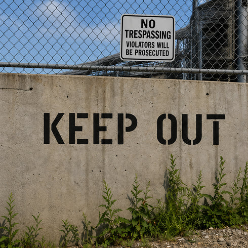 Keep Out Stencil used on a concrete wall in front of private property.
