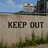 Keep Out Stencil used on a concrete wall in front of private property.