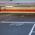 A photo showing a 'STOP' stencil applied on a parking space, painted in white on the asphalt surface.