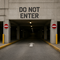 Concrete entrance with 'Do Not Enter' sign and arrow on pavement