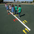 Children standing on a marked playground surface with colored footprints.