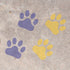Purple and yellow Wild Cat Paw Prints stenciled on concrete.