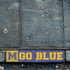 Brick border along a sidewalk with 'M GO BLUE' stenciled onto it