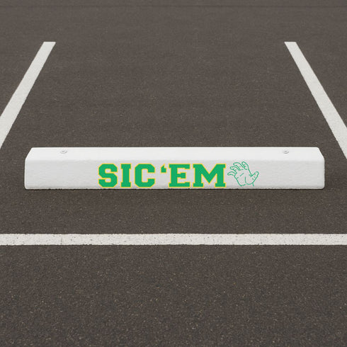 White parking spot bumper stenciled with the Sic 'Em Curb Painting Stencil.