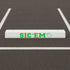 White parking spot bumper stenciled with the Sic 'Em Curb Painting Stencil.