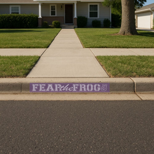 TCU Sign stencil with 'FEAR the FROG' on a sidewalk in front of a house.