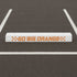 white parking bumper stenciled with the Go Big Orange Curb Painting Stencil
