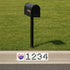 Black mailbox on a grassy area with a street address sign featuring the Chicago Cubs logo.