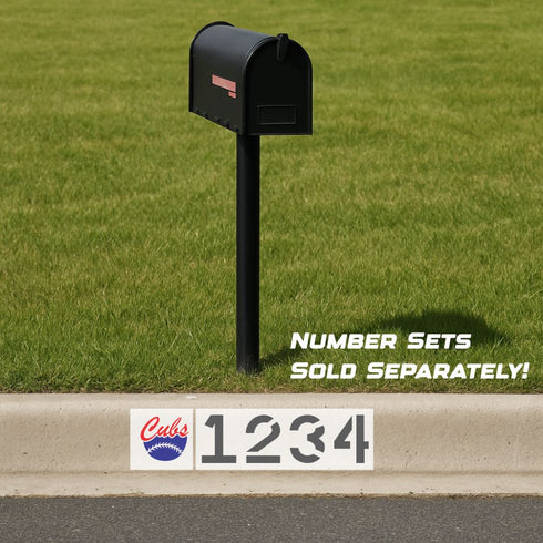 Black mailbox on a grassy lawn with Cubs-themed address numbers displayed.