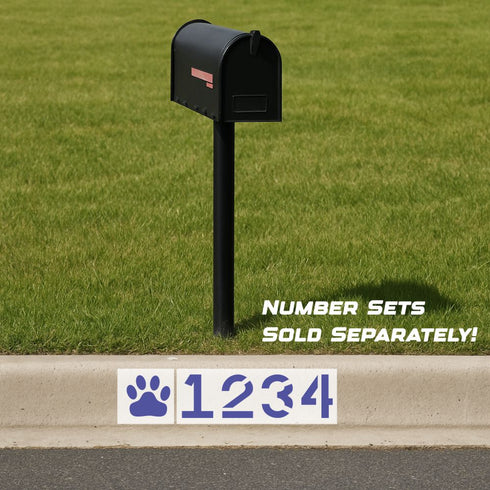Wildcats Curb Painting Stencil spray painted onto a residential curb under a mailbox.