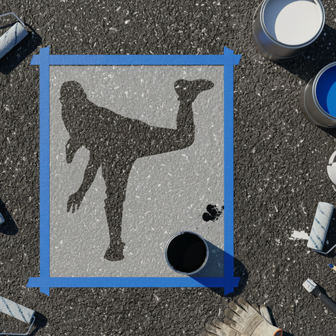 Baseball Pitcher stencil being applied to asphalt.