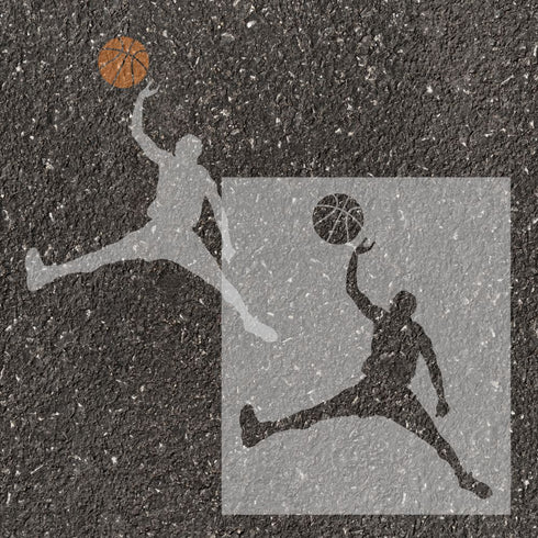 Men's basketball player silhouette stenciled onto pavement with matching stencil.
