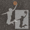 Silhouette of a basketball player taking a shot on an asphalt parking space with an inset showing a close-up of the stencil.