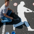 Student painting a mural on a parking lot with baseball player stencil