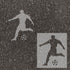 Men's Soccer player silhouette stenciled on pavement with matching stencil.