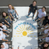 Group of people painting a mural with a sun and 'the future is bright' text on a large surface.