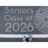 Person standing on pavement that has been stenciled with 'Seniors Class of '26' text.