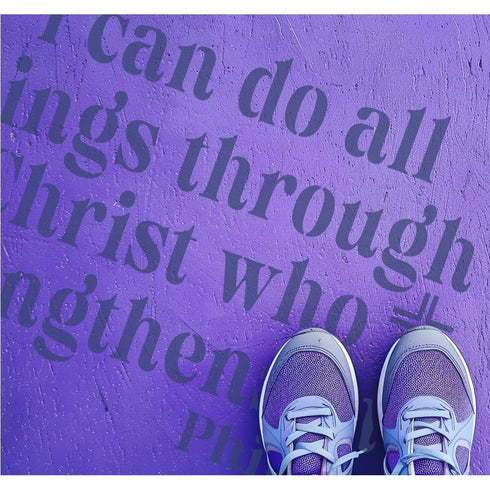 Person standing on pavement that has been stenciled with the Philippians Bible Verse.