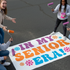 Four High School friends painting a colorful parking space with Taylor Swift text and decorative elements.
