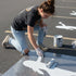 Taylor Swift silhouette stenciled on pavement with matching parking space stencil.