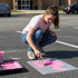Doll Head stenciled on pavement with matching parking space stencil.
