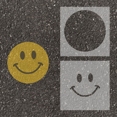Smiley Face stenciled on pavement with matching parking space stencil.