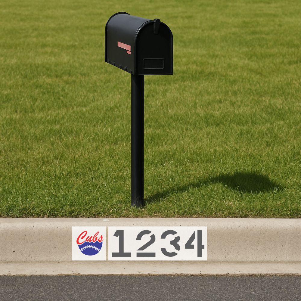 Black mailbox on a grassy area with a street address sign featuring the Chicago Cubs logo.